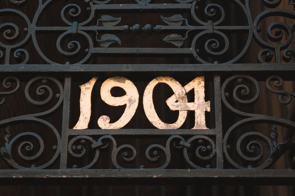 Decorative wrought iron gate with a vintage scrolled design.